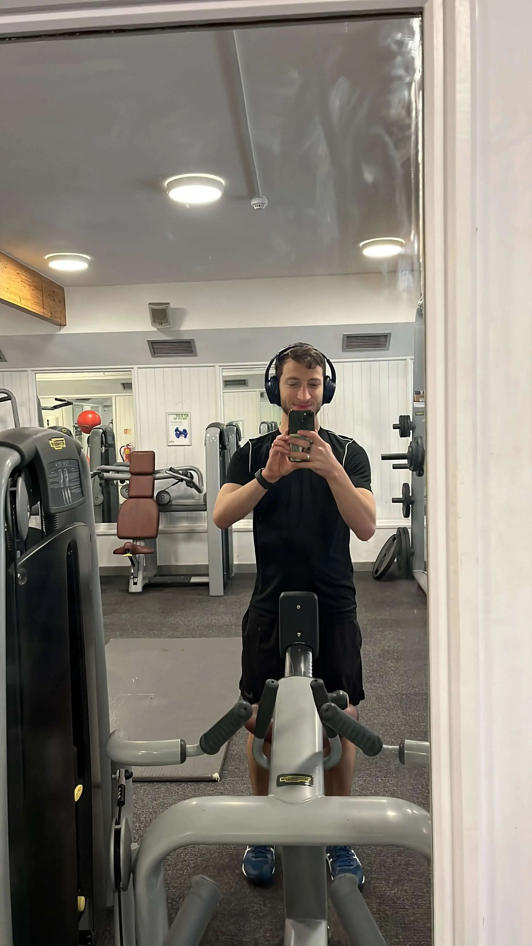 Taking a mirror selfie at the gym